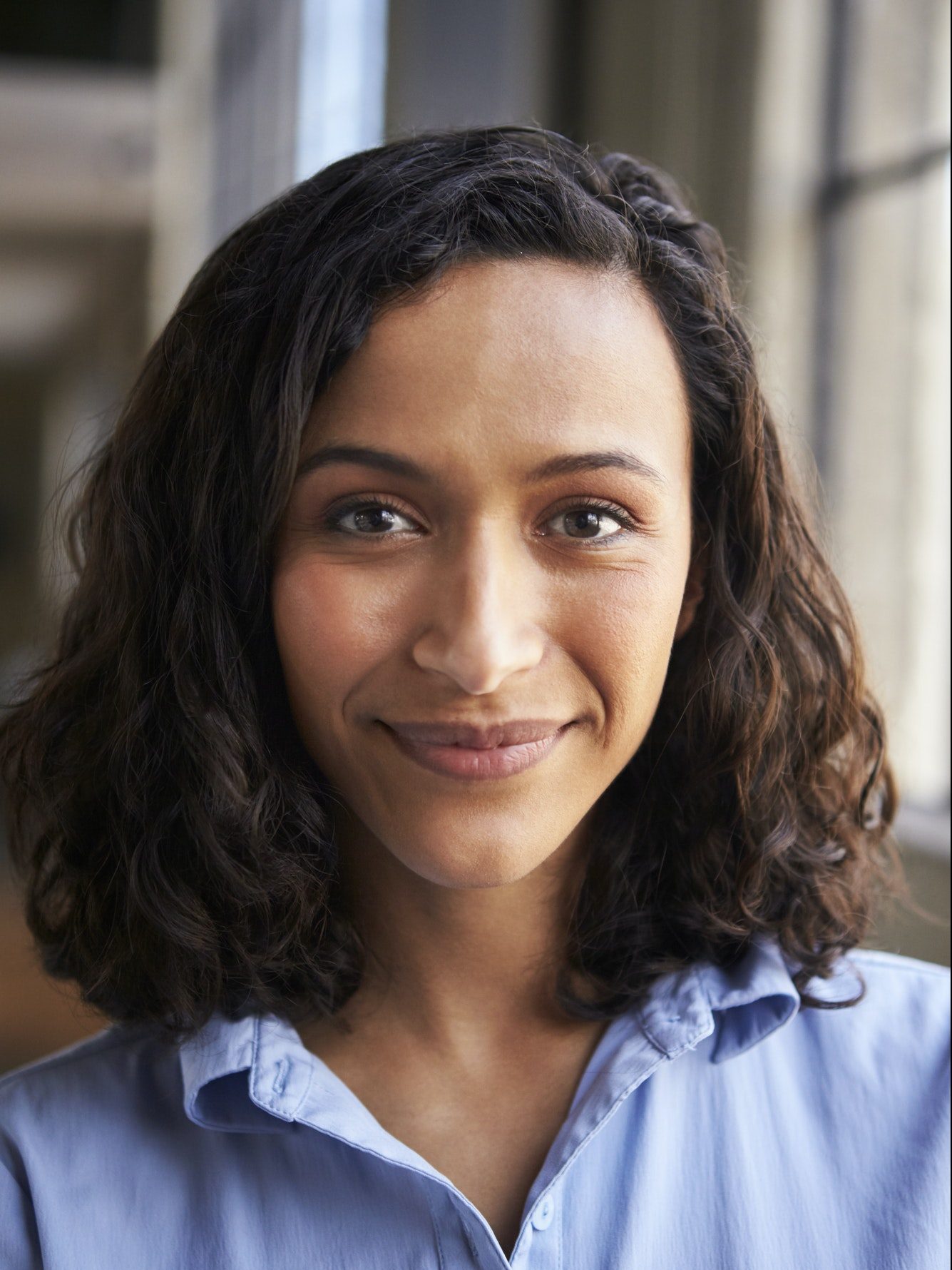 Close up portrait of smiling mixed race businesswoman