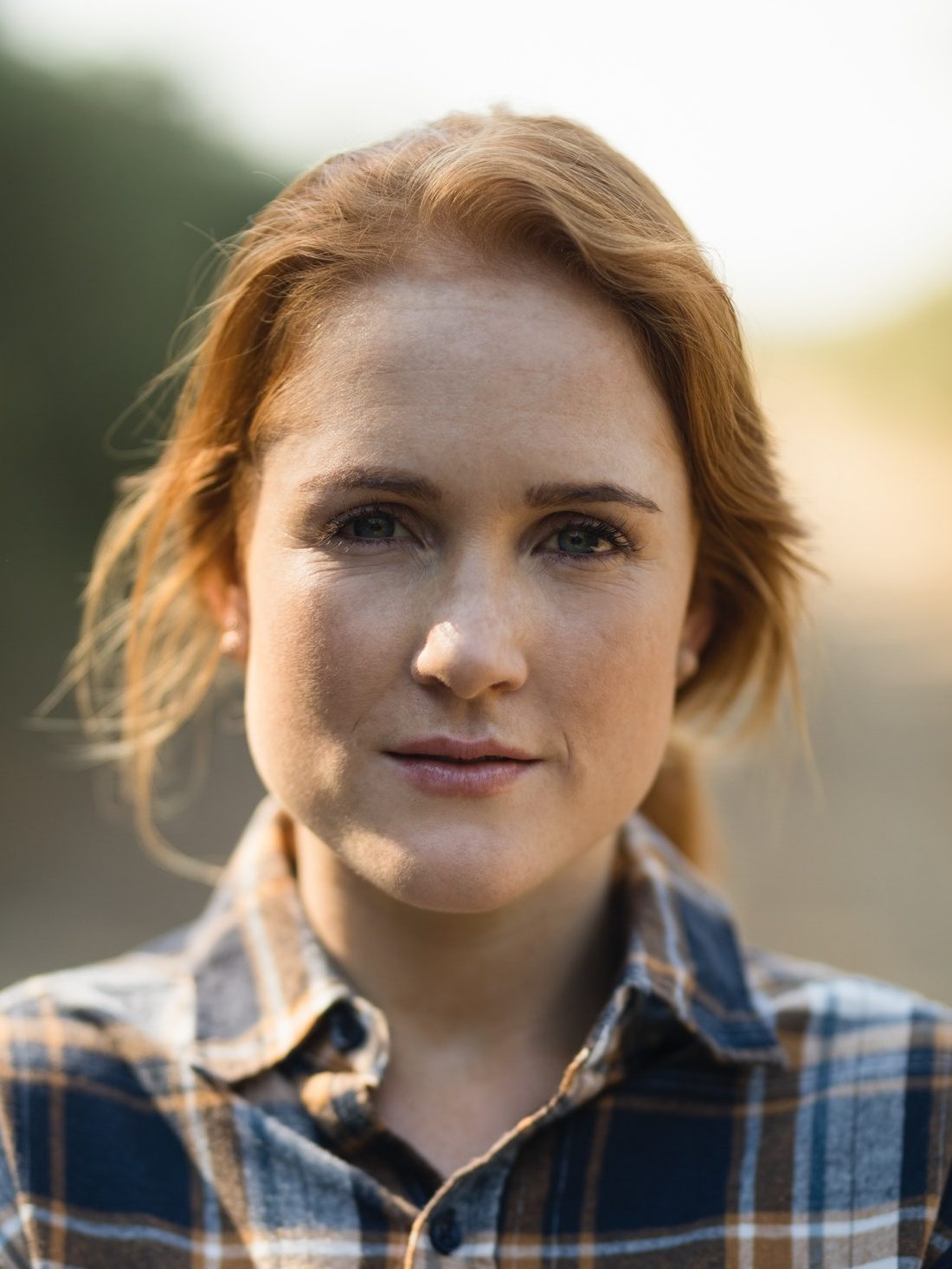 Portrait of beautiful young woman at farm