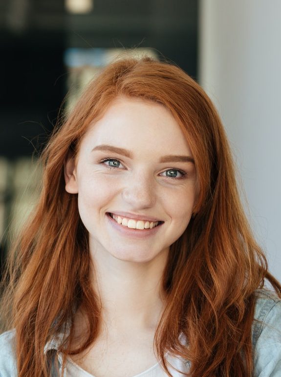 Portrait of redhead student in cafe